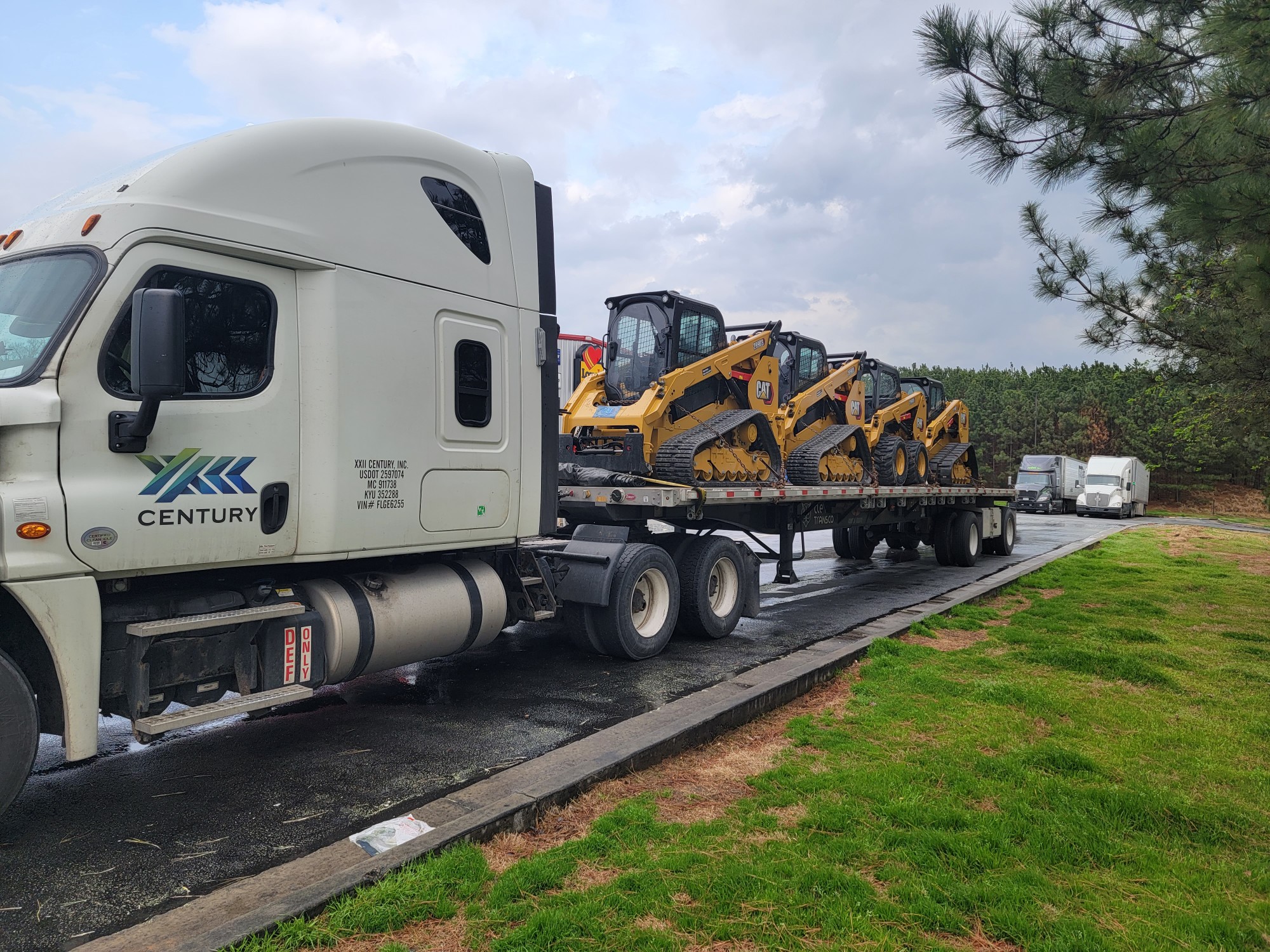 owner operator transporting machinery in the truck